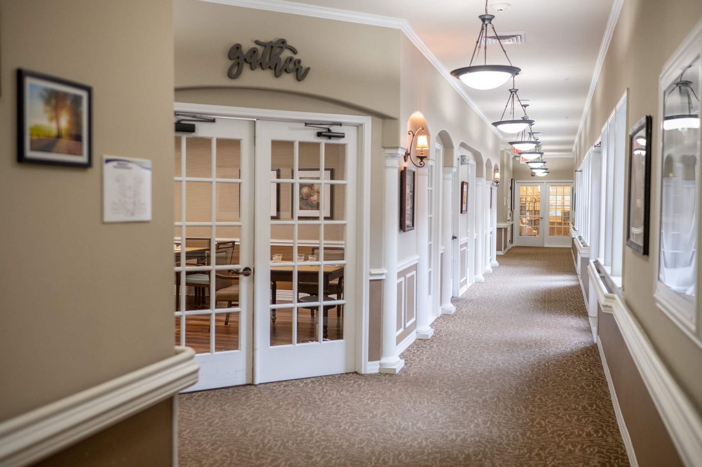 A well-lit corridor in a senior care facility.