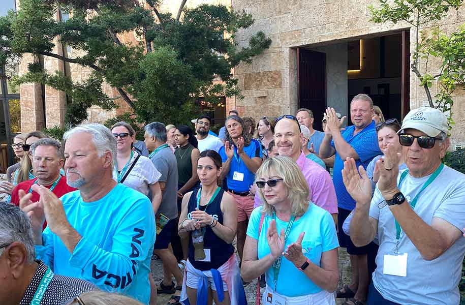 Group of people clapping outside the facility