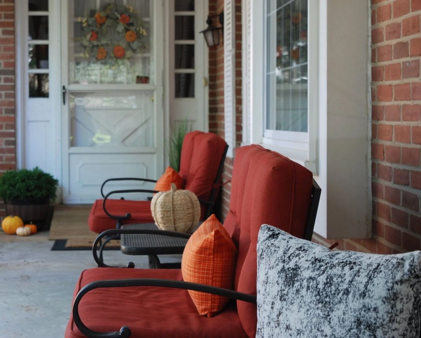Chairs on a porch with seasonal decorations