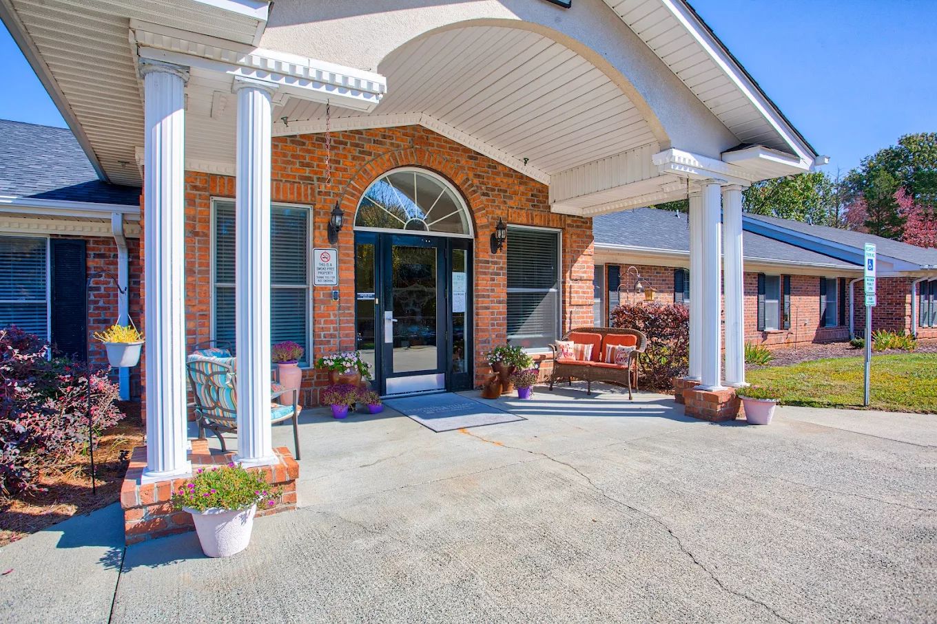 Entrance of Clemmons Village I with columns and seating area
