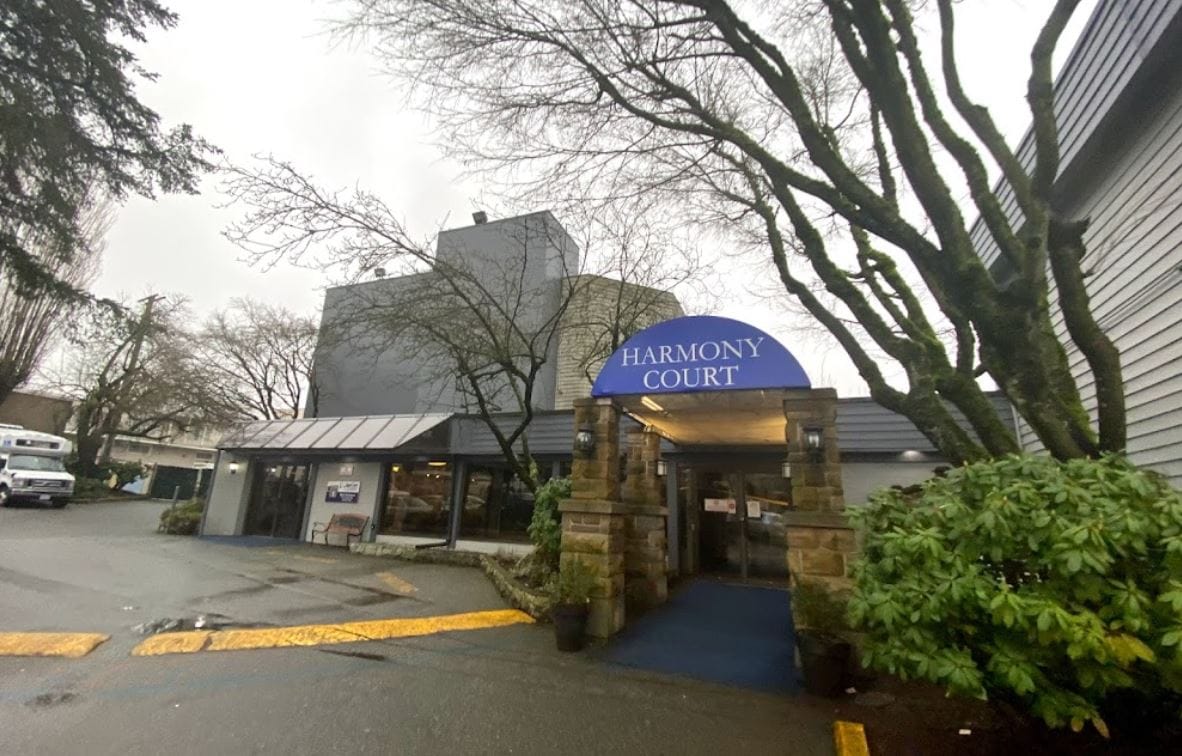 Entrance of Harmony Court Estate with trees and garden
