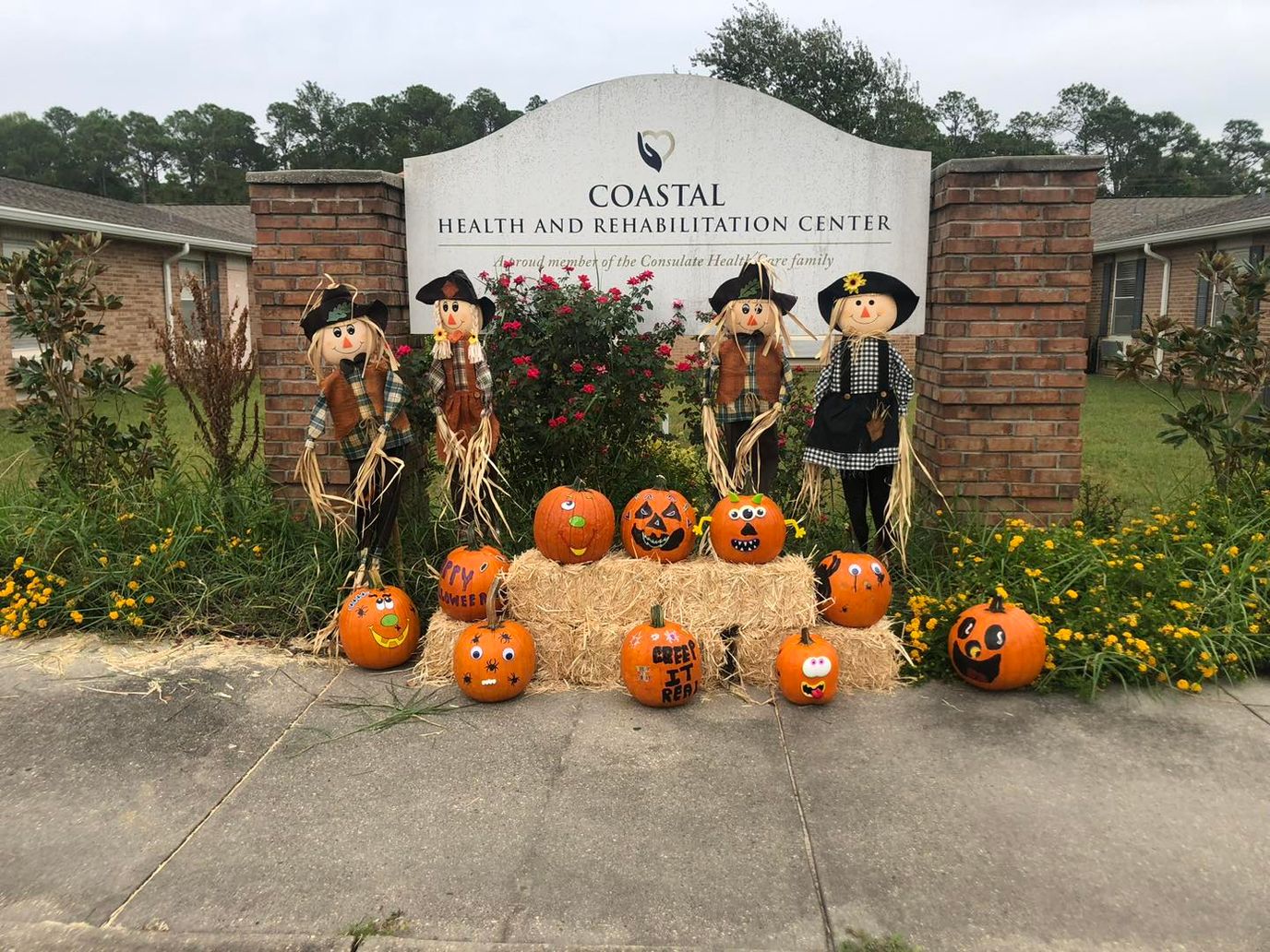 Fall decorations with pumpkins and scarecrows at the facility entrance