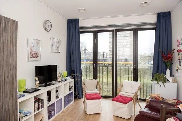 Cozy interior of a resident's room with chairs and a TV