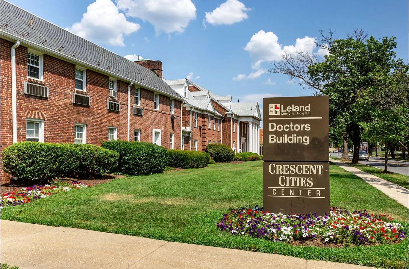 Exterior view of Crescent Cities Center with landscaping