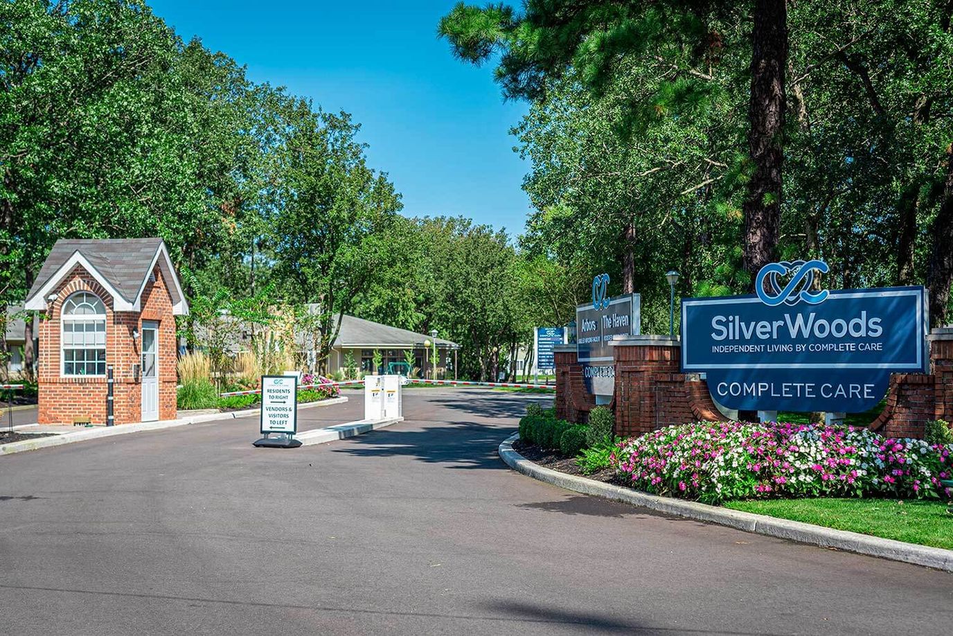 Entrance of Complete Care at Silverwoods with signage and flowers