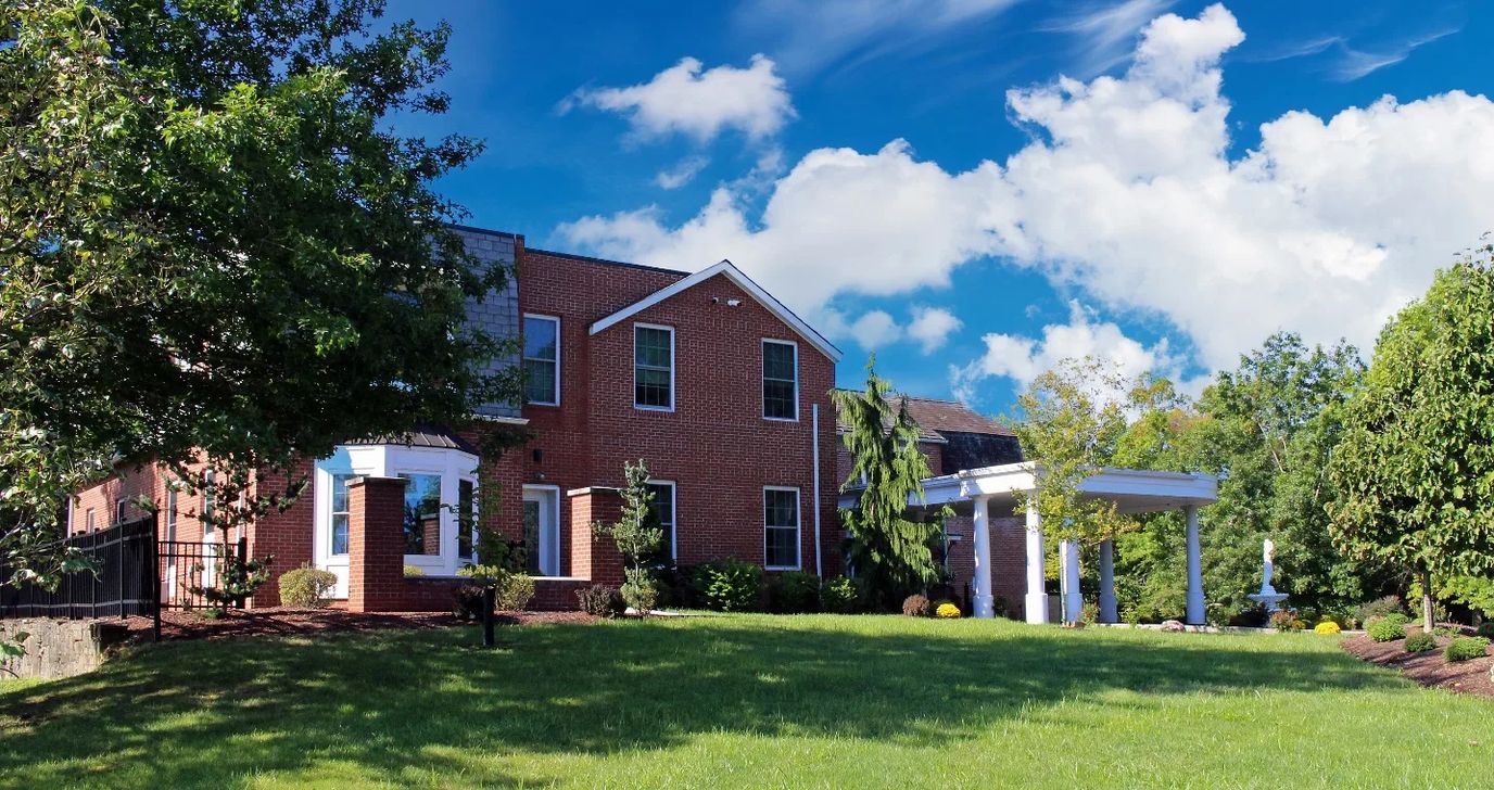 Exterior view of a senior living facility surrounded by greenery