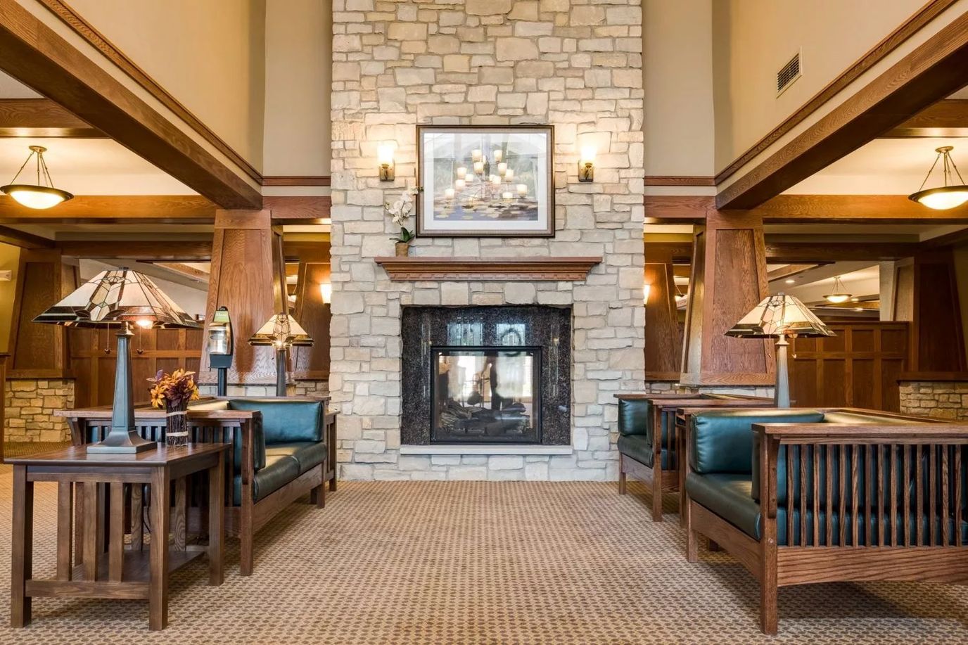 Lounge area with stone fireplace and wooden seating