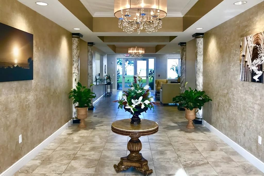 Welcoming lobby featuring plants and decorative lights