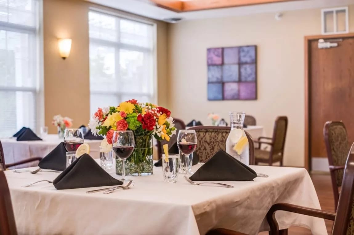 Heritage West Allis, assisted living in Milwaukee, WI — Elegant dining setup with flowers and wine glasses