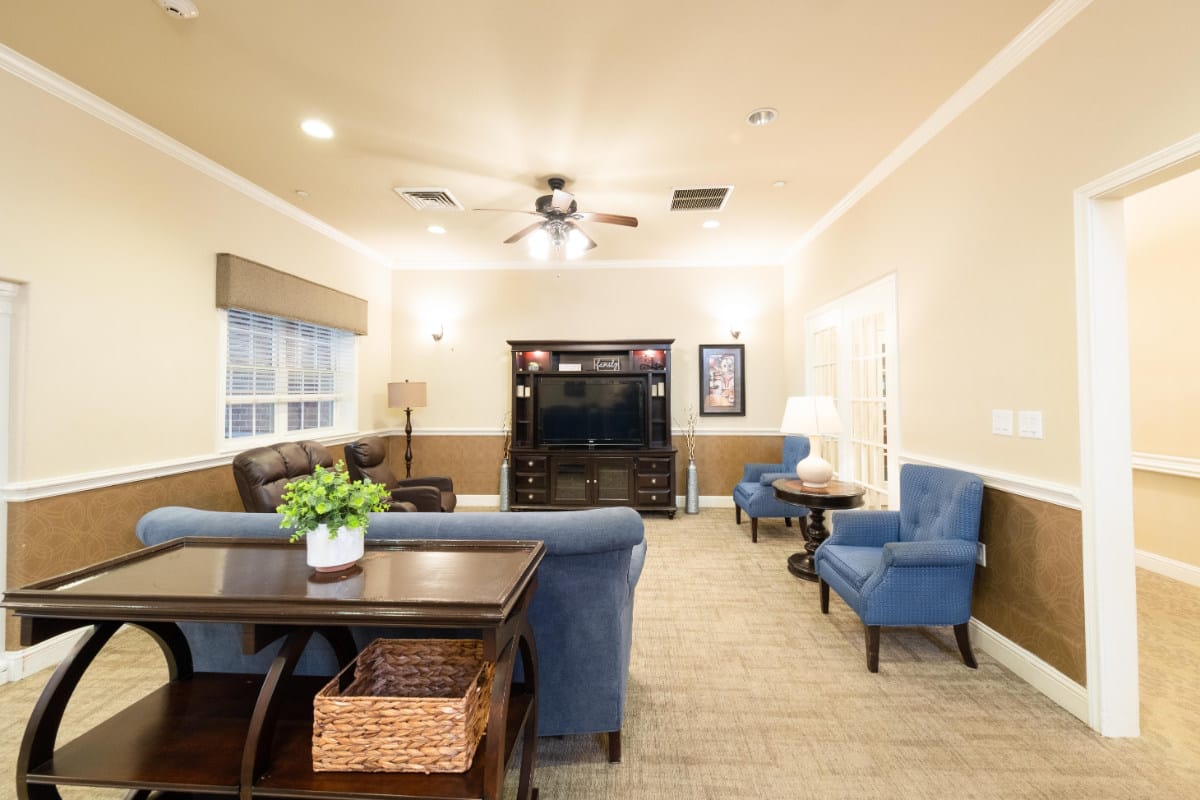 A comfortable living room with seating and a TV cabinet