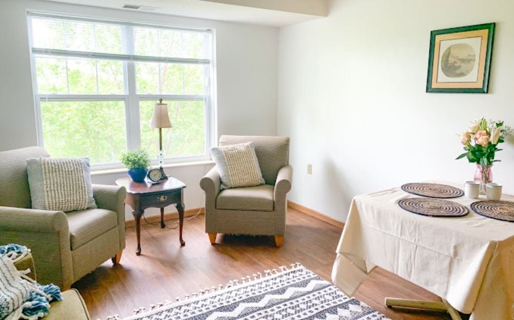 Cozy seating area with two chairs, table, and window view