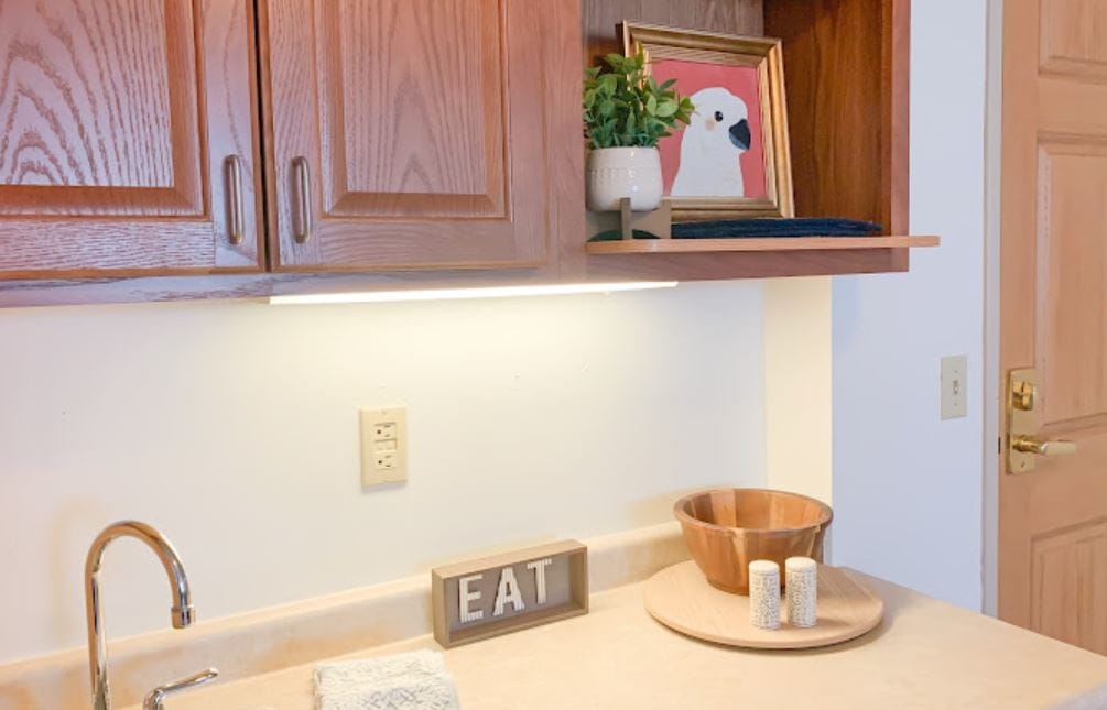 Kitchen area with wooden cabinets and decor