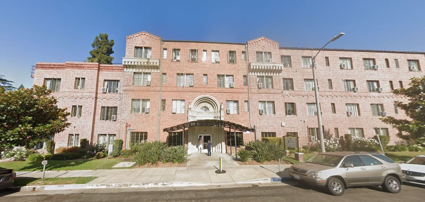 Building exterior of Kingsley Manor with residents entering