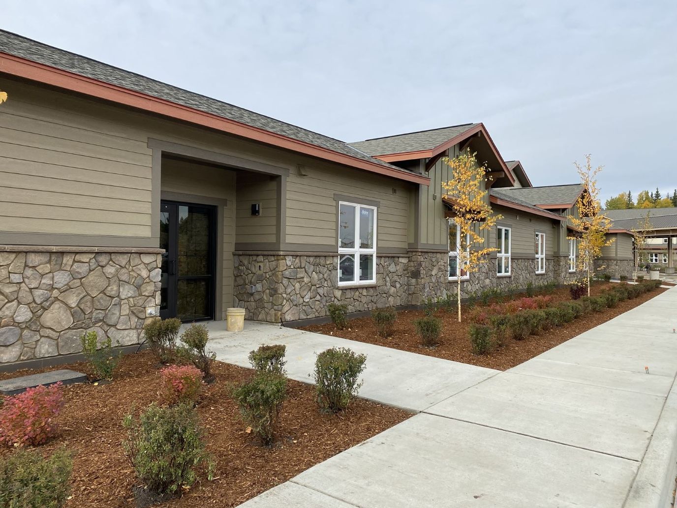Exterior view of Maple Springs of Anchorage with landscaped entrance