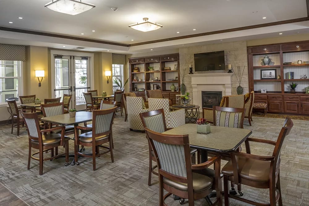 Spacious common area with seating and a fireplace.