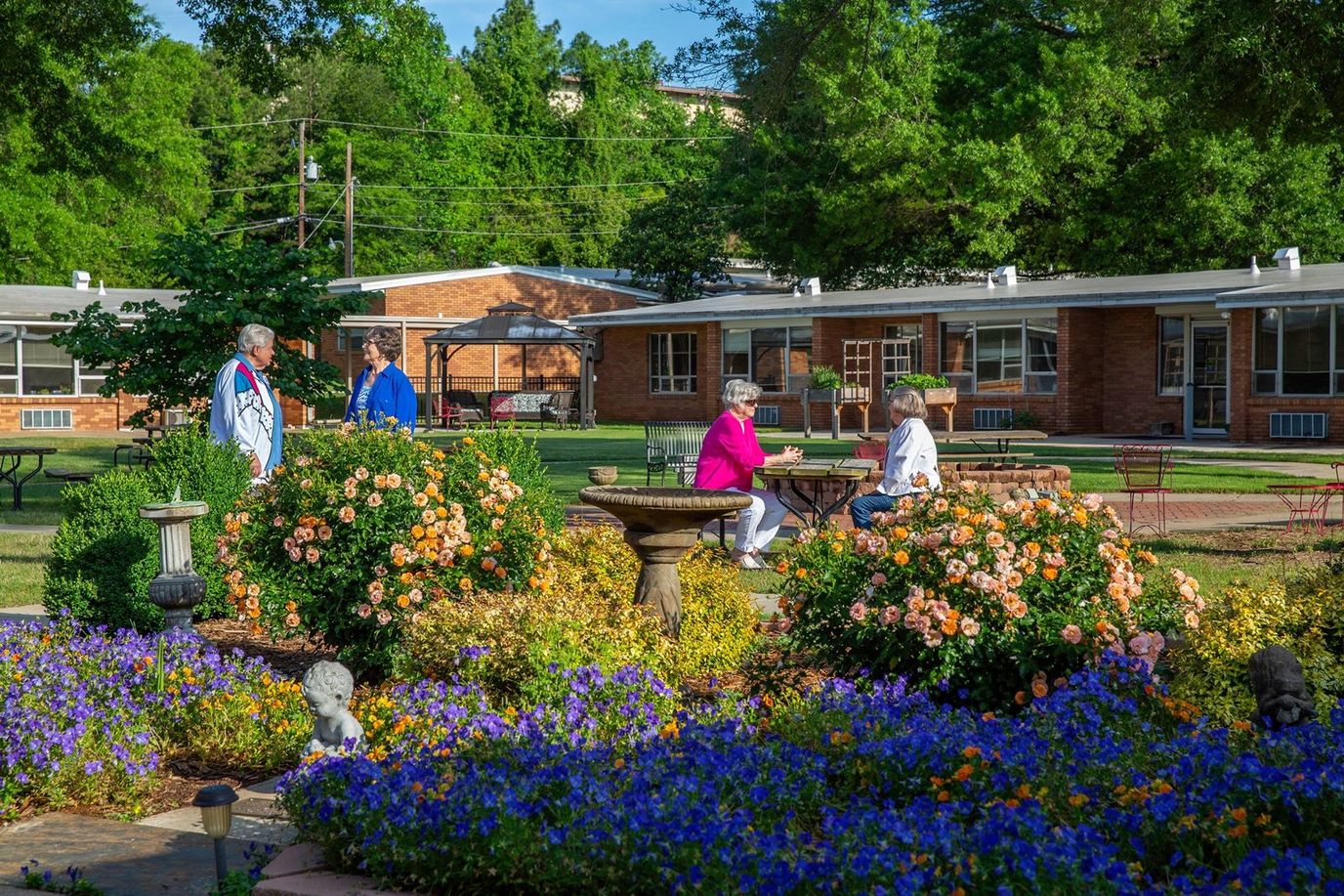Residents enjoying the garden area with flowers