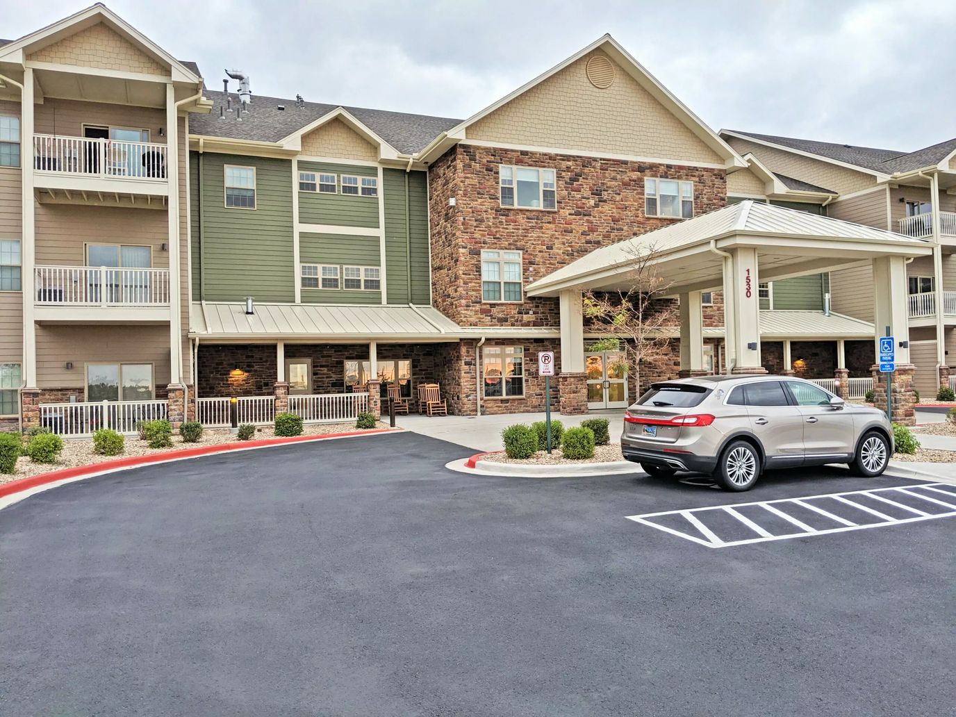 Front exterior of Primrose Retirement Community with parking area