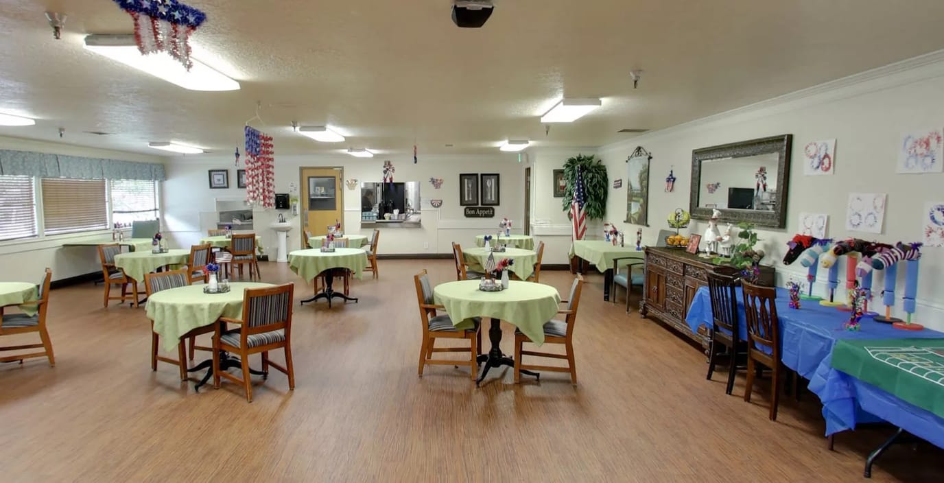 Interior view of a dining area with tables set up for residents
