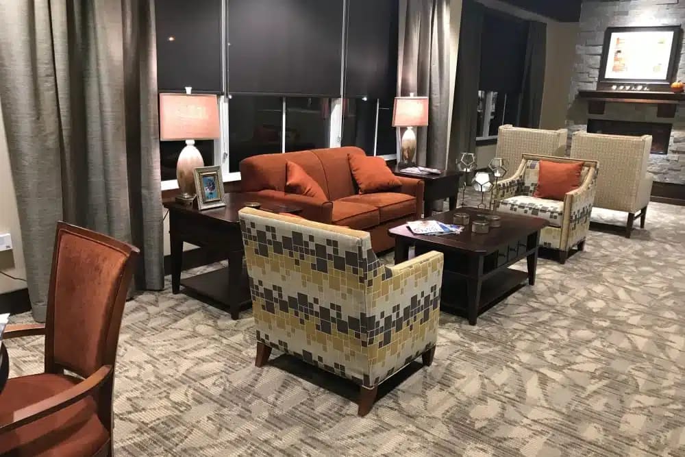 Lounge with comfortable seating and lamps at The Heritage at Sagewood