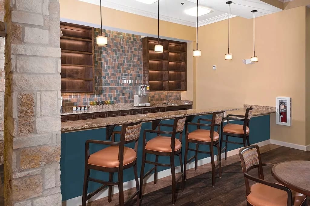 Stylish bar area with seating and colorful tile backsplash