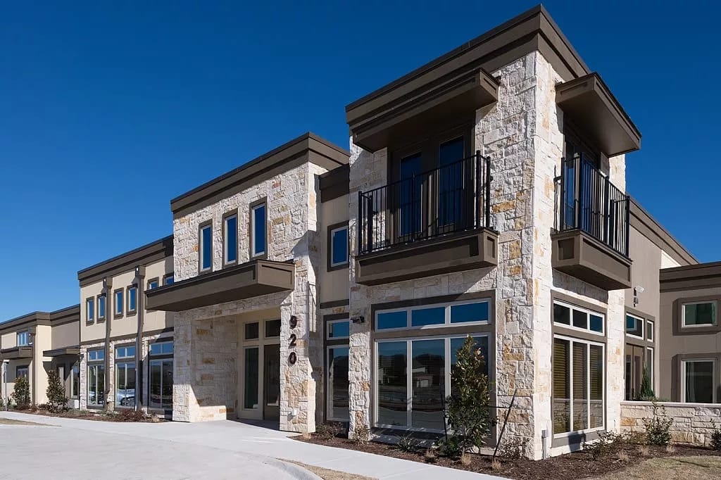 Modern building exterior of The Heritage at Twin Creeks in Allen, TX