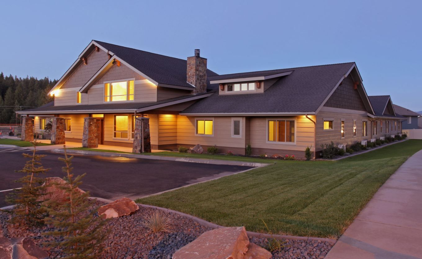 Exterior view of a senior living facility at dusk