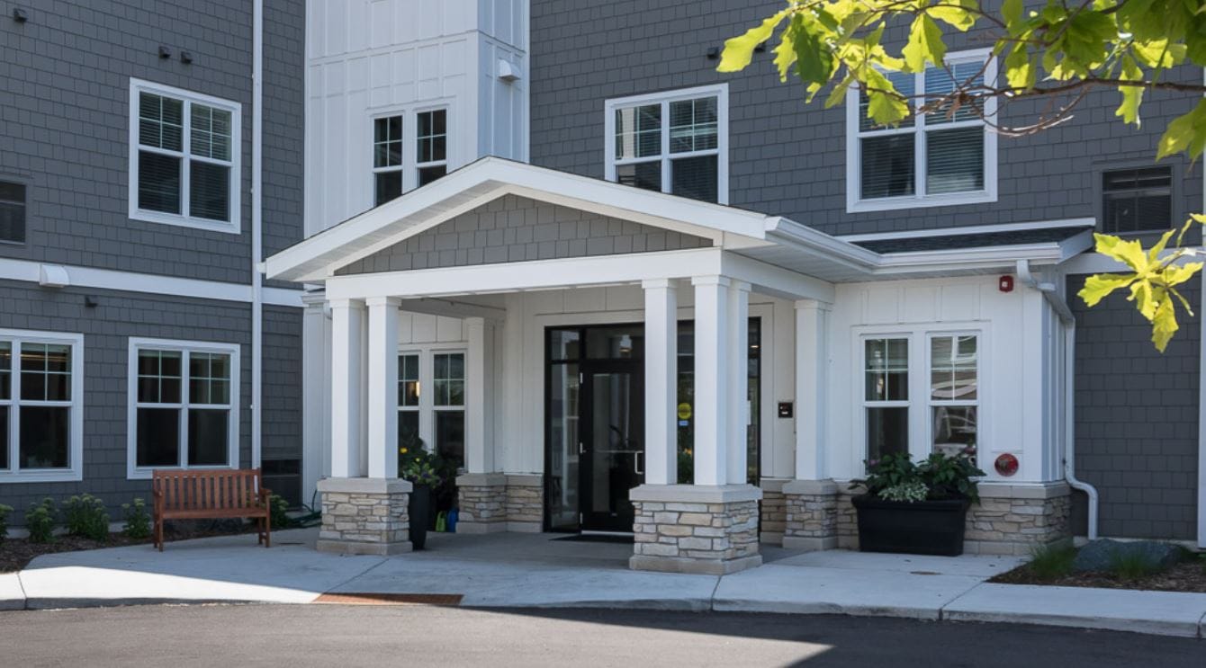 Front entrance of a senior living facility with landscaped area