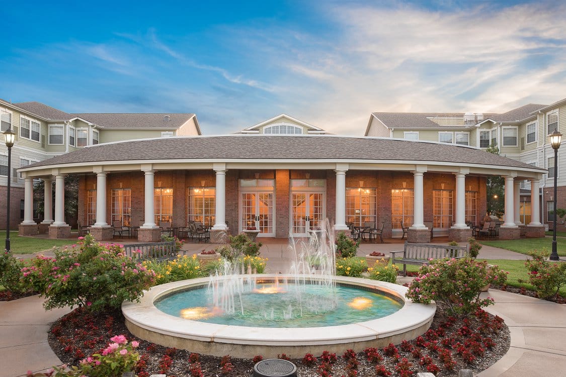 Exterior view of the retirement community with a fountain