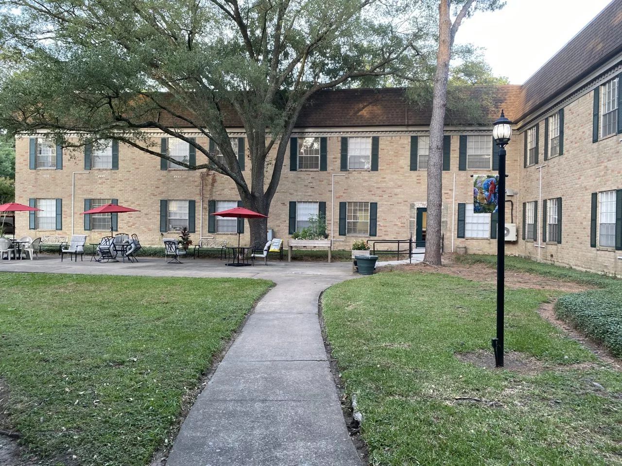 Exterior view of the facility with patio seating and landscaping