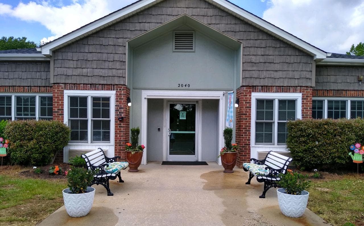 Front entrance of Willow Ridge with flower pots and benches