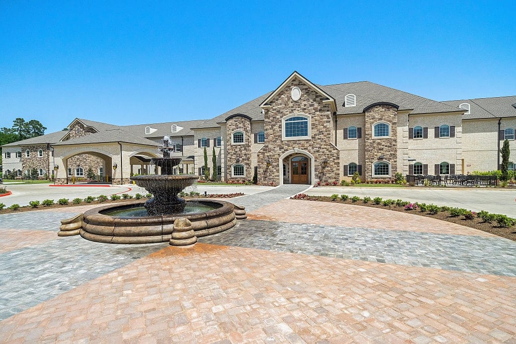 Exterior view of Worthington Manor with fountain and gardens