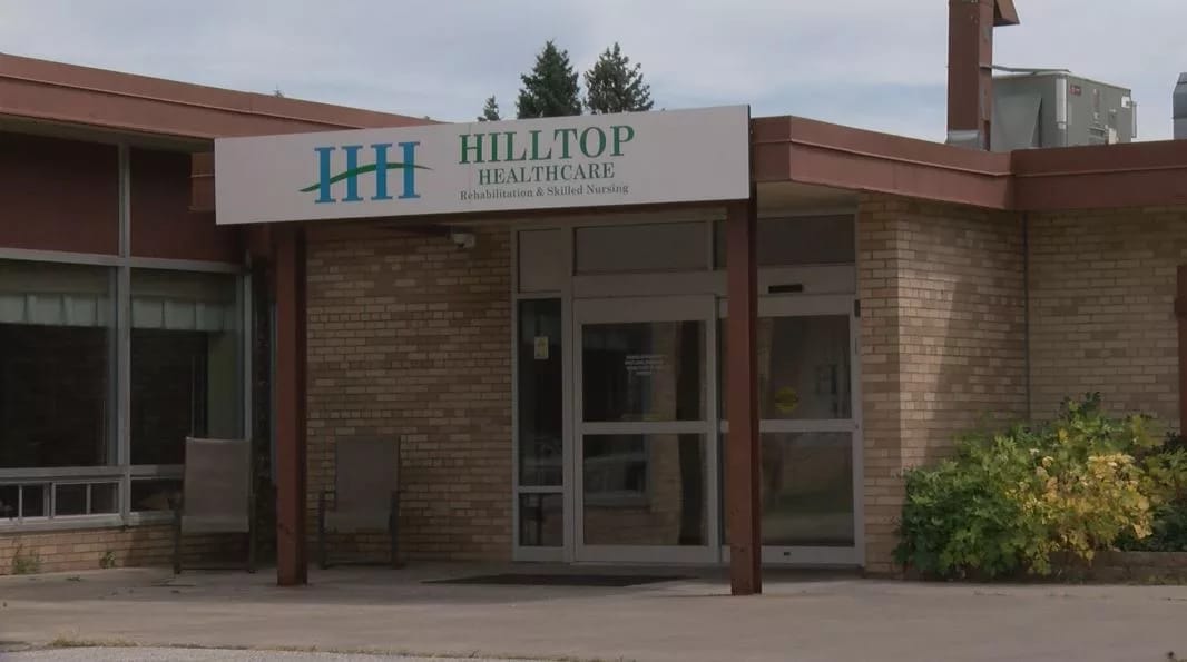 Entrance of Hilltop Healthcare facility with signage