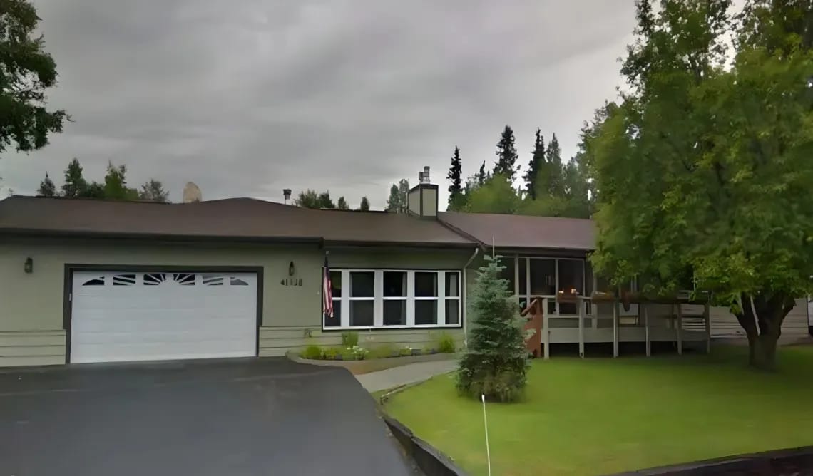 Exterior view of a senior care facility surrounded by greenery