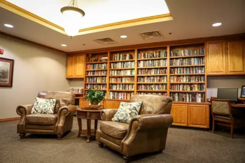 Cozy lounge area with bookshelves and seating