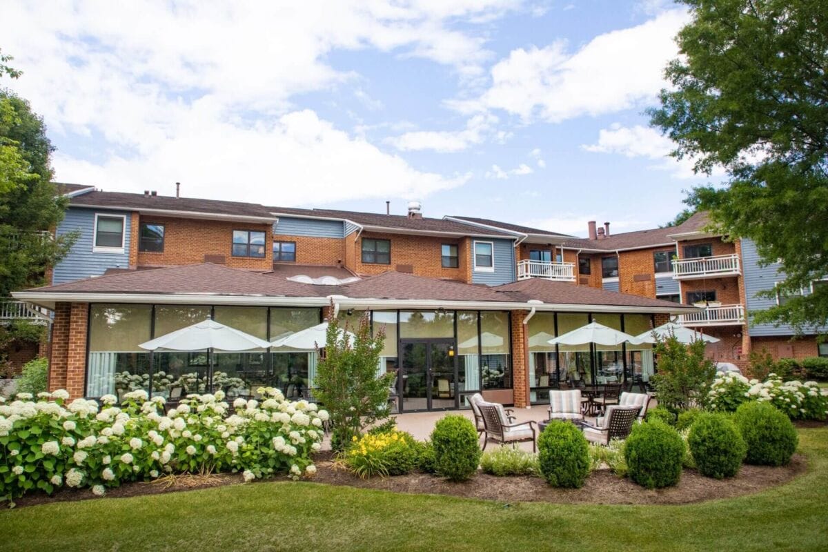 Exterior view of the assisted living facility with gardens