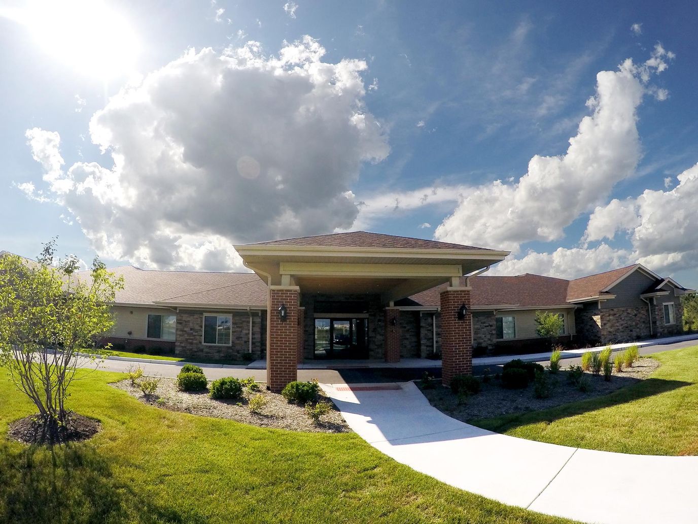 Entrance of a senior living facility with landscaping