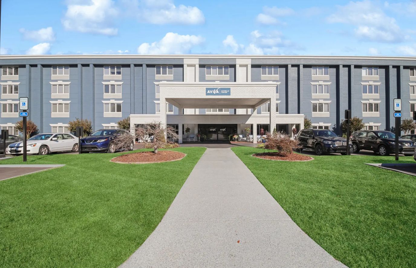 Front entrance of a senior living facility with landscaped area