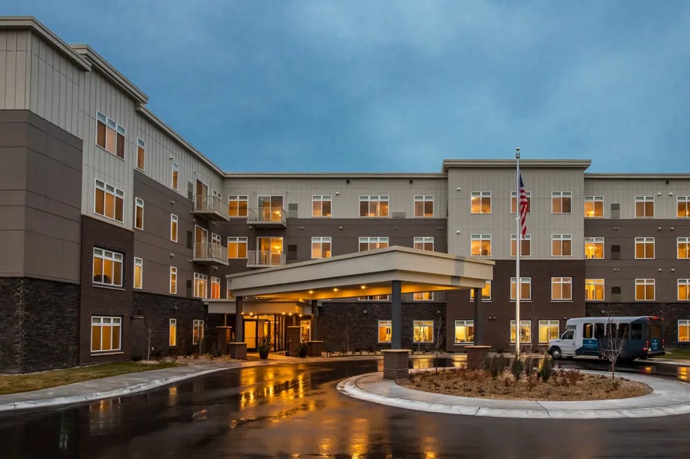 Exterior view of Broadwell Senior Living facility at dusk