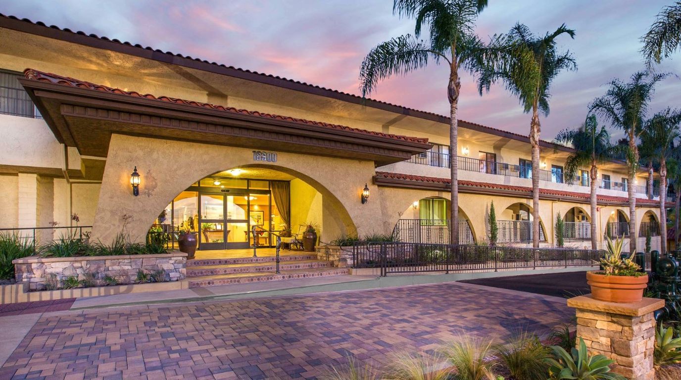 Exterior view of Huntington Terrace facility with palm trees