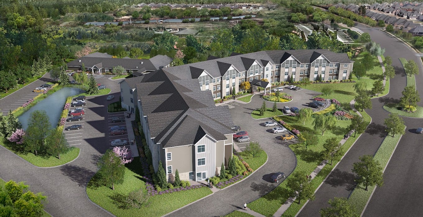 Aerial view of assisted living facility with landscaped grounds