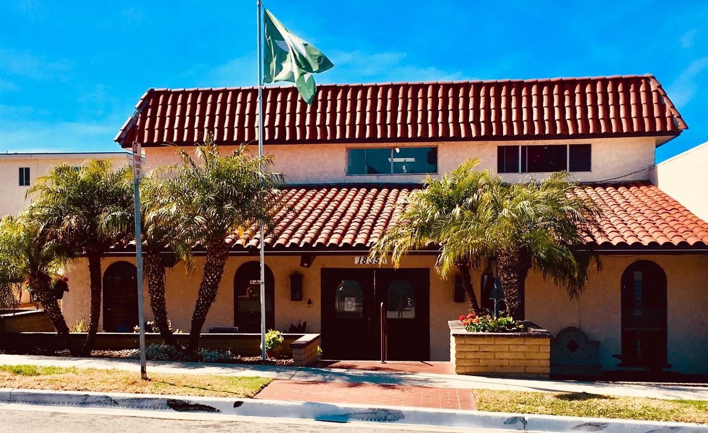 Entrance of Sea Cliff Assisted Living with palm trees