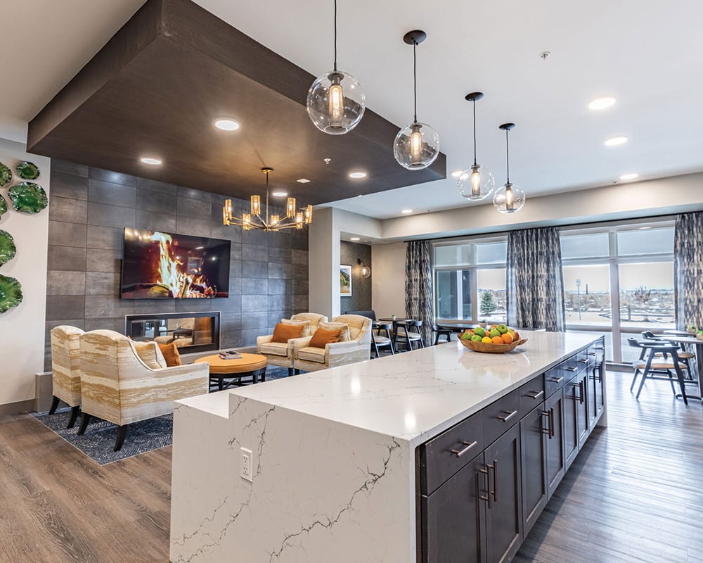 Bright common area with seating and a kitchenette