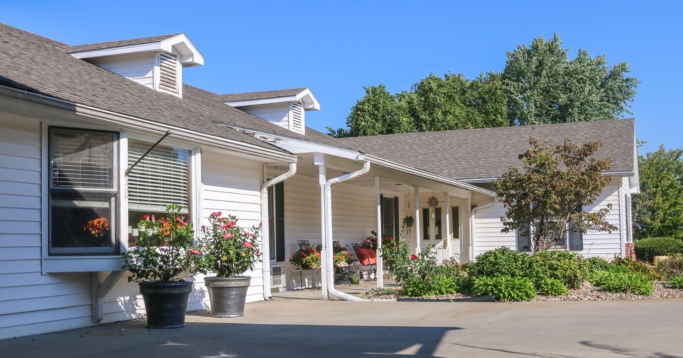 A view of the exterior of a nursing home with landscaping