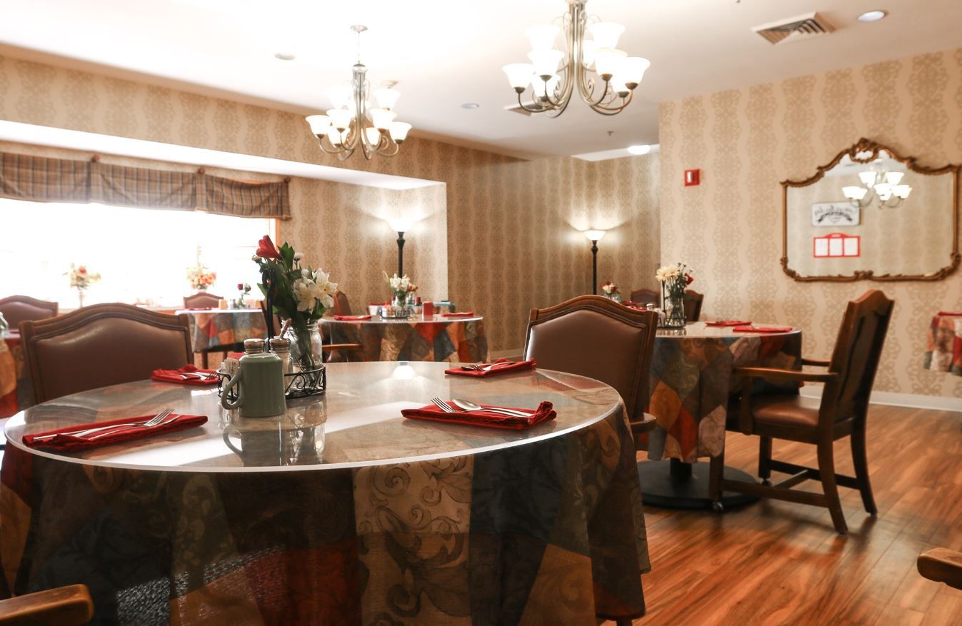 Elegant dining room setup with decorated tables and chairs