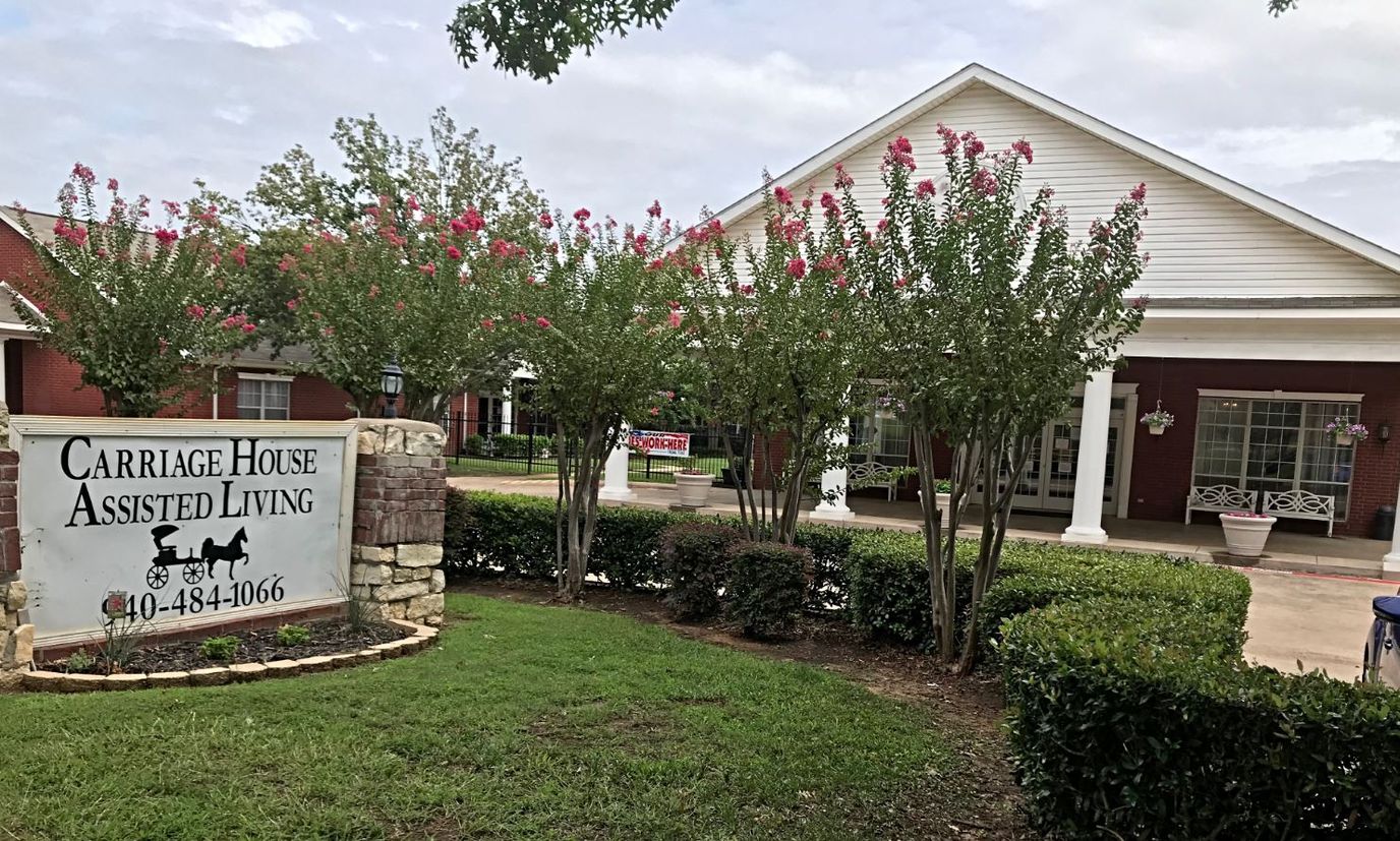 Exterior view of Carriage House Assisted Living with landscaping