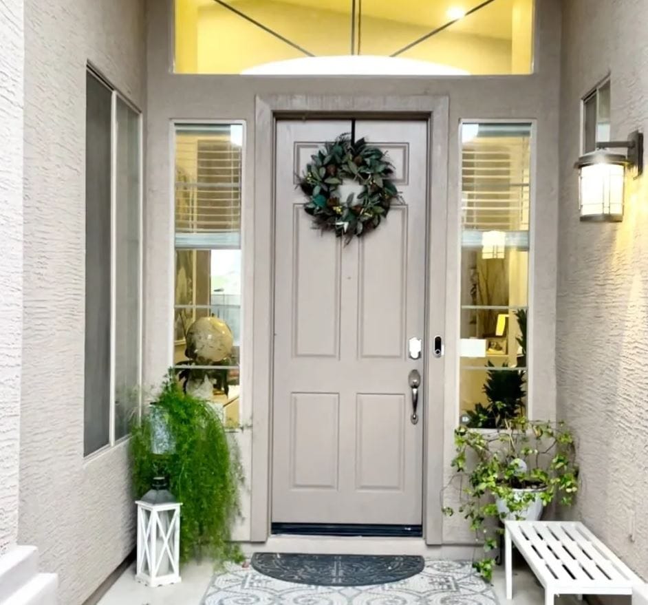 Front entrance of a senior living facility with greenery