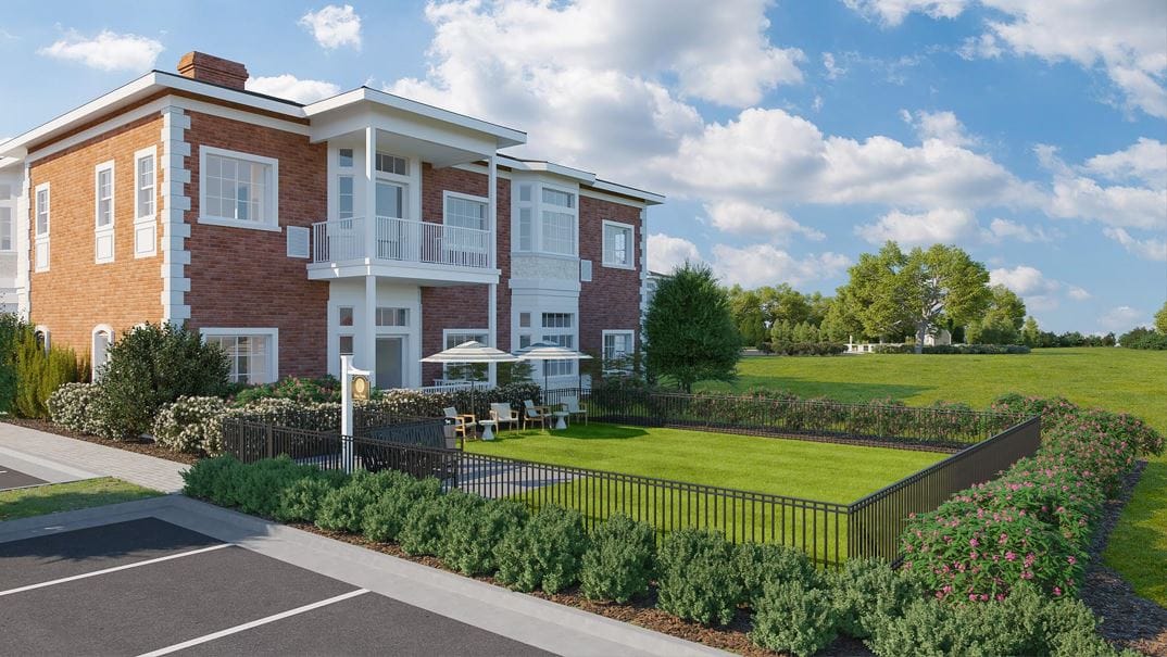 Exterior view of the facility with gardens and seating area