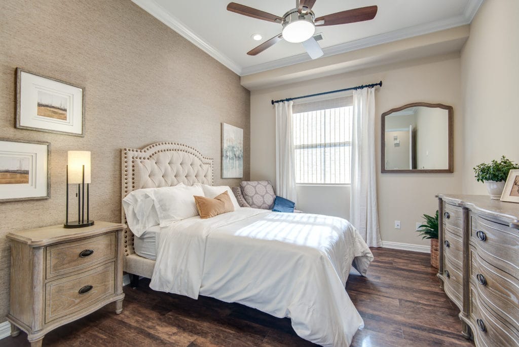 Brightly decorated resident room with a bed and furniture