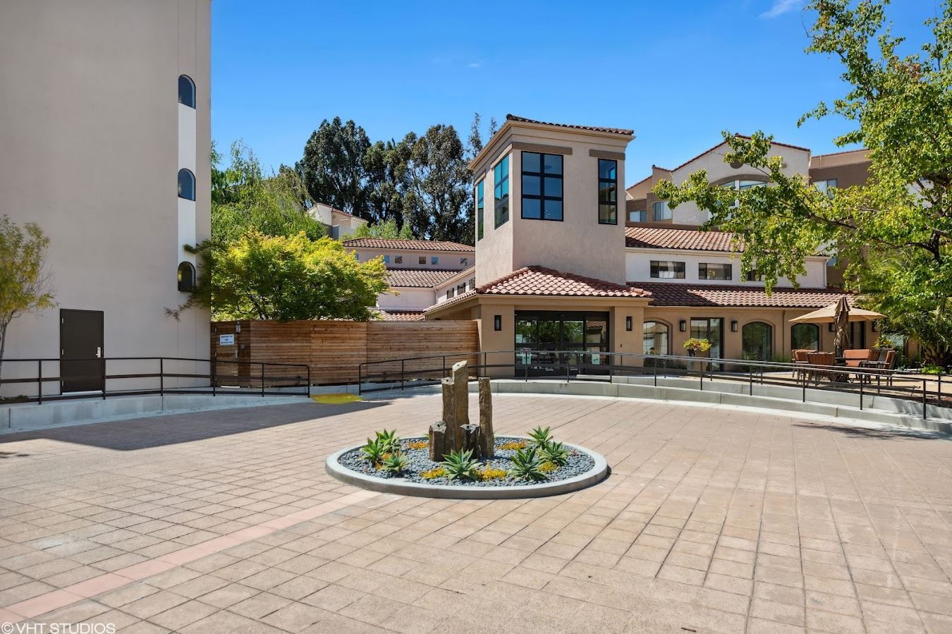 Outdoor courtyard with landscaping and water feature