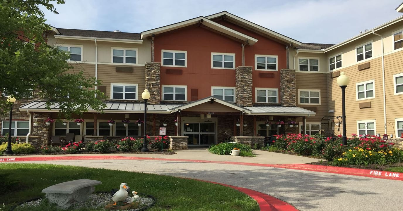 Exterior view of Delaware Highlands Assisted Living with flowers